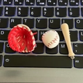 Mini baseball glove and bat keychain in red and white set against a glowing keyboard - 3-piece Mini Charm / Red