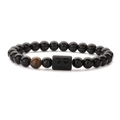 Detailed macro view of Gemini zodiac obsidian bracelet with brown tiger eye bead - Lion