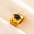 Detailed macro view of vintage gold ring with black oval stone and sunburst texture - Gold-Black