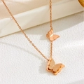 Elegant rose gold butterfly necklace with matte textured pendant on a white marble display - X1223 Butterfly Necklace Rose Gold