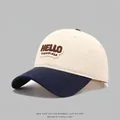 Close-up of HELLO embroidery on cotton color-block baseball cap with navy blue brim - 54cm (3-8 Years) / Beige and Navy Blue
