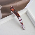 Macro shot of large tortoiseshell acetate hair claw clip on white velvet tray - 8# Dark Amber Curved Horn Clip