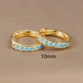 Macro view of 10mm gold hoop earrings set with round blue turquoise stones - 10mm / Gold (Blue Zircon)