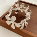 Close-up of silver flower bracelet with sparkling crystals on elastic cord details - Silver
