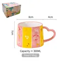 Pink and yellow striped ceramic mug with heart handle and 300ml capacity in gift box - Mystery Symbol (Gift Box)
