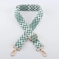 Macro view of green and white geometric jacquard strap with gold lobster clasps - Light Gold Buckle / Light Green