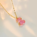 Detail of pink resin bear pendant with gold star zircon and sleek water wave chain - Pink Lip Chain