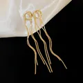 Macro detail of elegant gold snake chain tassels on minimalist metal flower earrings - Round Ring Snake Chain Tassel Style (16#)