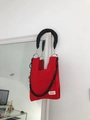Detail of red hollow crochet handbag featuring thick black chain and brand label - Red + Shoulder Strap Set