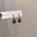 Detail of silver drop earrings featuring smoke gray geometric crystals and zircon inlay - Dark Grey Faceted Crystal Hook Earrings
