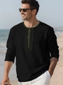 Detail of black cotton linen Henley shirt with olive green trim on beach background - S / Black