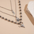 Detail showing western boot, cowboy hat, and bull skull pendants on triple layer necklace - Silver (3-Piece Set)