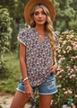 Close-up of floral print summer top for women paired with denim shorts in outdoor garden - L / Black