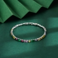 Macro view of multi-colored zircon stones on a silver metal chain bracelet - Silver