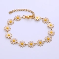 Macro detail of bohemian golden chain bracelet featuring white enamel daisy flower charms - Bracelet / White Flower
