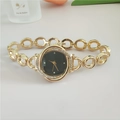Detail of gold floral watch with black dial and crystal bezel on a chain bracelet - Gold Color Black