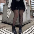 Sheer black pantyhose with butterfly print paired with skirt and boots in industrial setting - One Size / Bow Black