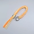 Handwoven orange and yellow paracord wrist strap with metal rings and tassel detail - Orange + Yellow