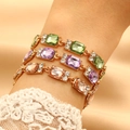 Elegante set di bracciali dorati con cristalli colorati taglio smeraldo e piccoli diamanti - Stili Champagne E Verde E Viola