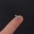 Mini gold heart earring with light blue zircon stones held by fingers for size scale - Gold Base Light Blue Zirconia (302-4#)