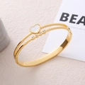 Golden heart shell bangle with cubic zirconia and textured stainless steel finish - Gold