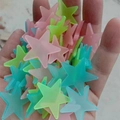 Hand holding colorful 3cm luminous star wall stickers in pink, blue and green tones - 100 Pieces / 3.8cm/Glow / Colorful