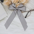 Elegant grey satin bow hair clip with long streamers on a soft decorative background - Gray