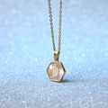 Gold plated hexagon necklace featuring white shell inlay and initial D pendant - Letter D
