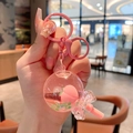 Pink peach themed liquid keychain with floating charm and cute cartoon bear bear design - Peach-Lollipop