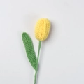 Close-up of a handmade yellow crochet tulip with green stem and leaf on white background - Finished Closed-mouth Tulip (yellow)