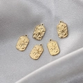 Five gold stainless steel North Star rectangle pendants on silver silk background - Gold