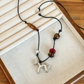 Detailed view of silver pony pendant on braided cord with wooden and amber beads - Silver Leather Agate Tiger Eye Beaded Slender Horse Necklace