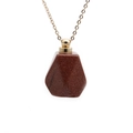 Macro shot of red-brown goldstone perfume bottle pendant with golden metal cap - Goldstone Perfume Bottle (Gold Chain)