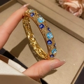 Gilded filigree bracelet with blue enamel flowers and sparkling crystals on hand - 3# Bracelet-Gold-Blue Enamel Hollow Filigree Style