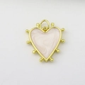 Detail view of heart-shaped gold charm with pink marble texture and micro-ball edges - Pink White