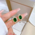 Close-up of gold-plated earring with green oval gem and micro-pave cubic zirconia - D336 Stud Earrings (Sterling Silver Pin Copper Gold Plated)
