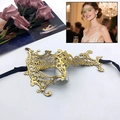 Elegant gold cutout lace masquerade mask with black silk ribbons for party events - One Eye Monster