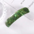 Detail view of a curved green checkered acetate hair clip with a glossy finish - 35# Spring Clip (Green Gold Faux Tortoise)
