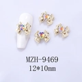 Macro shot of 12x10mm gold bow nail charms with AB heart rhinestones and model display - Gold Base Light of Heaven Heart (9469)