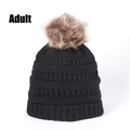 Detail of chunky knit winter beanie for adults with fluffy pom-pom in deep black - Black