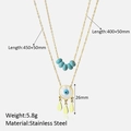Detail view of double-layer stainless steel gold necklace with shell evil eye pendant - Gold