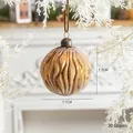 Amber textured Christmas glass ball ornament 7.7cm hanging on a snow-covered pine branch - Bronze Patterned Glass Ball