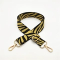 Detail of zebra pattern bag strap with adjustable buckle and gold metal lobster hooks - Yellow on Black