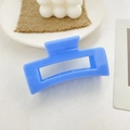 Bright blue geometric hollow hair claw clip with glossy finish and metal spring - Blue