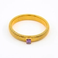 Macro detail of golden Tubogas snake bracelet featuring a faceted purple zircon stone - 12mm Width x 18cm Circumference / Purple