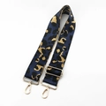 Macro view of leopard print wide bag strap featuring polished light gold metal lobster clasps - Dark Blue With Gold Buckle