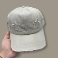 Detail of star embroidery and distressed ripped brim on beige vintage baseball cap - Adjustable / Off White
