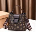 Brown handbag with letter pattern print and adjustable shoulder strap in studio lighting - Vintage Pattern Double Straps