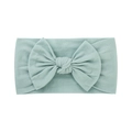 Soft pale green nylon baby headband featuring a large fabric bow on a white background - Light Pink Green