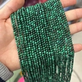 Faceted malachite micro beads with natural green bands held in hand, 3-4mm size - Malachite 3mm